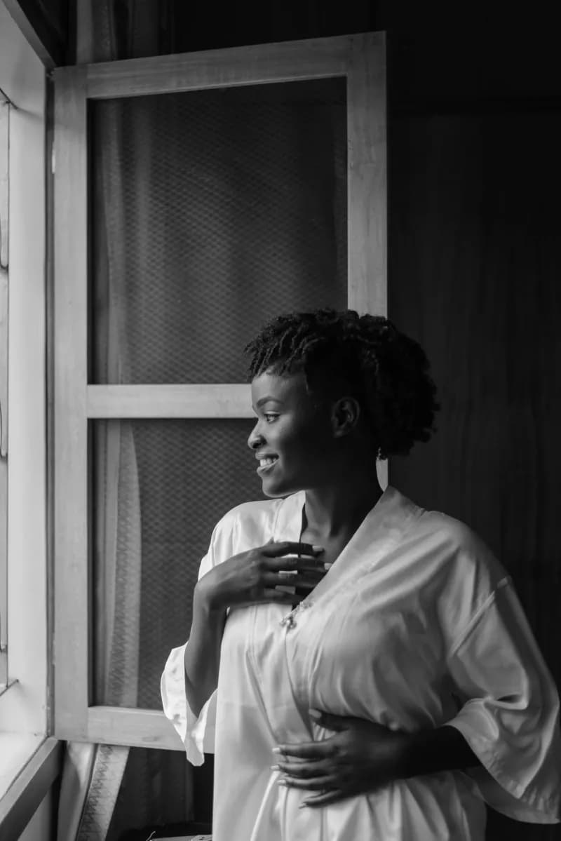 A woman in a quiet moment by a window